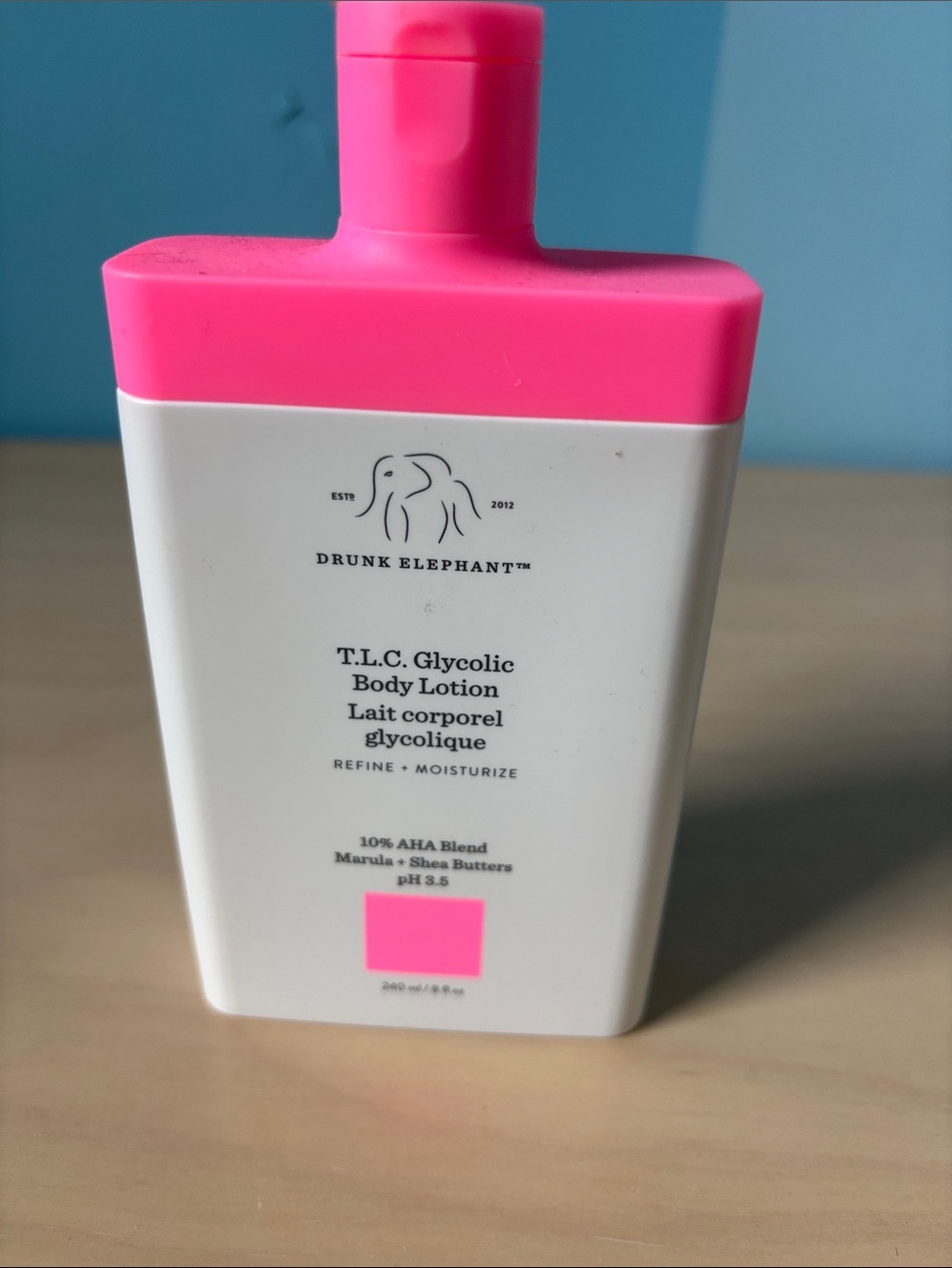 Drunk Elephant Body Lotion Bottle with Bright Pink Accents